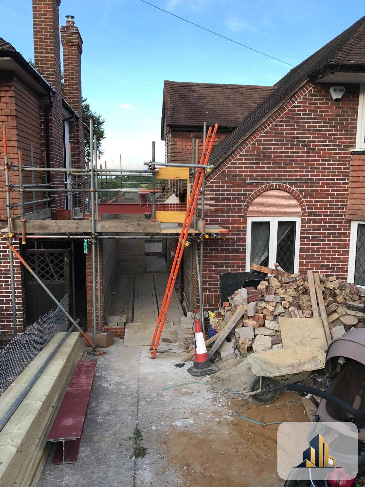 Two-storey side extension under construction with scaffold and steel beam, Banstead
