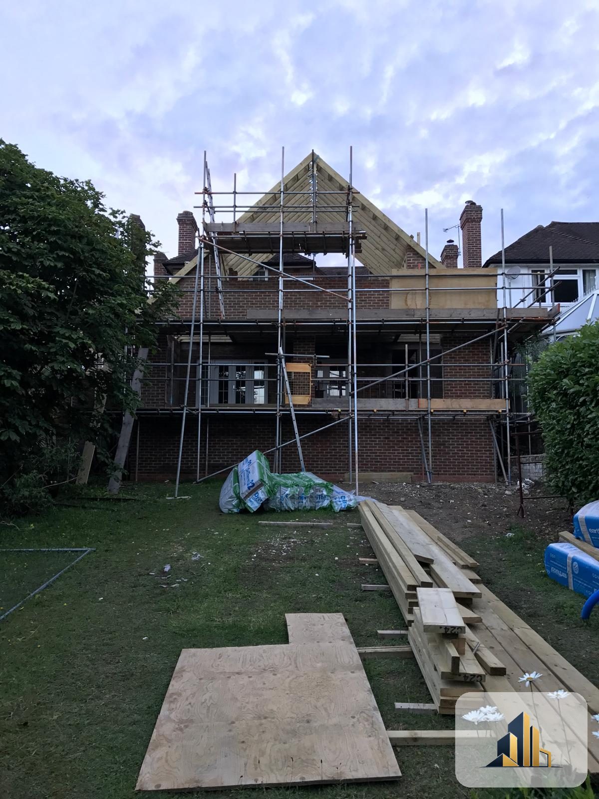 Rear of the Banstead house scaffolded with the new apex gable being framed in timber