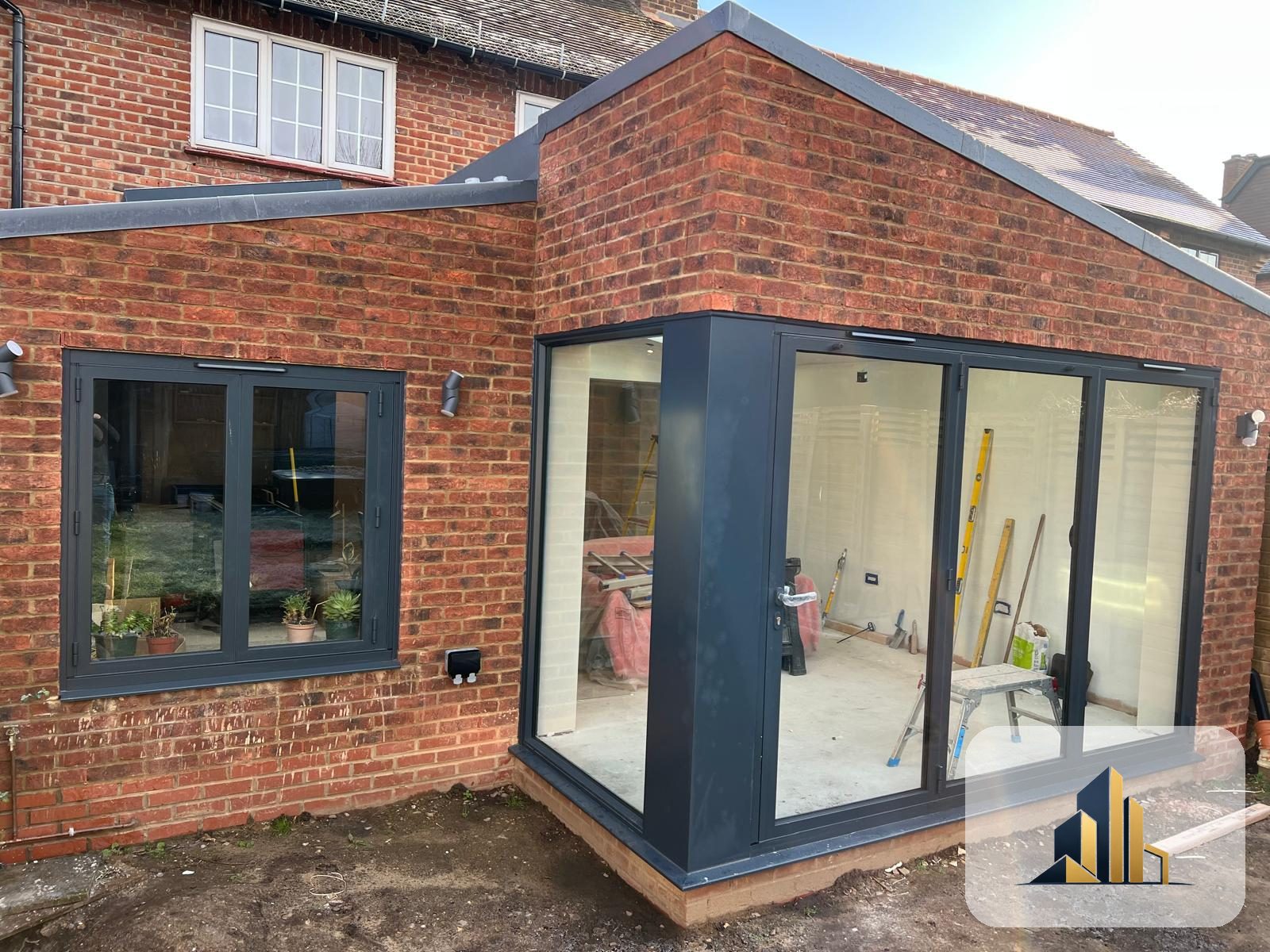 Finished Richmond rear extension with brick, anthracite bifold doors and corner window in daylight