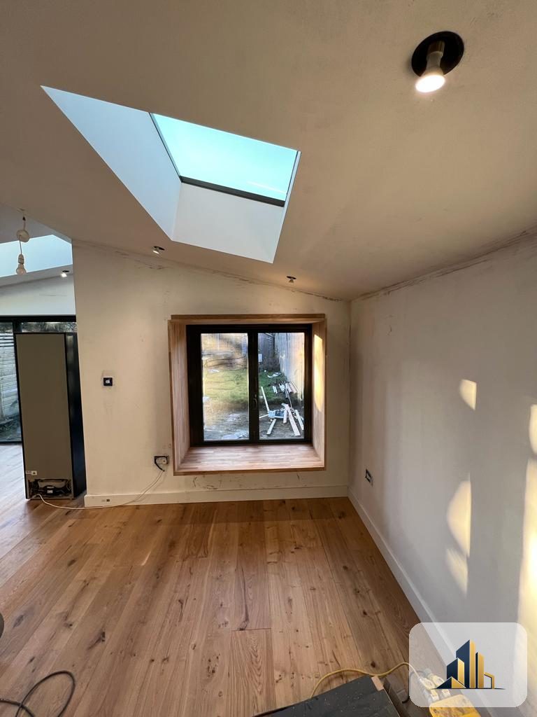 Interior of the Richmond extension with oak flooring, a roof lantern and a bespoke oak window seat